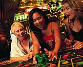 Surprised Woman Sitting Between Friends in a Casino Reaching For a ... Surprised Woman Sitting Between Friends in a Casino Reaching For a ...
